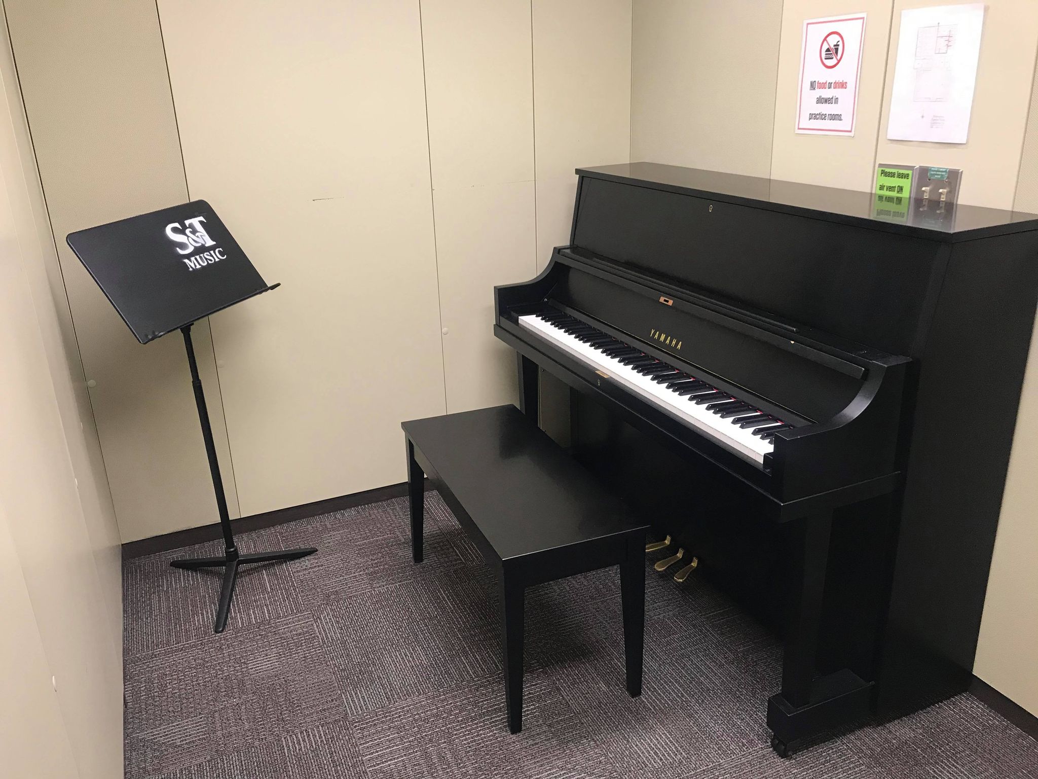 Photo of piano and music stand in a practice room